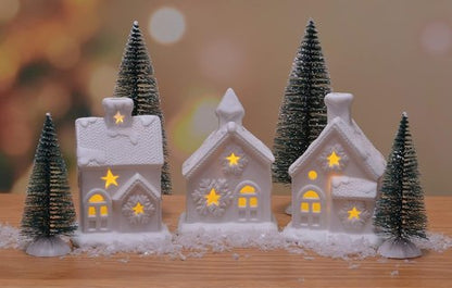 Mark Feldstein & Associates Pre-Lit LED Cozy Knit Winter Village - 7 Piece Unglazed Porcelain Tabletop Set