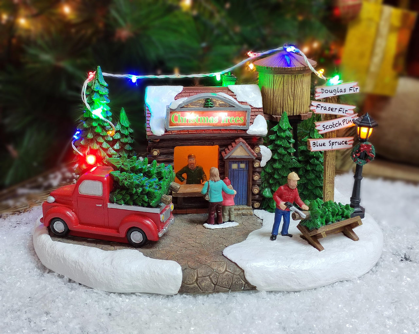 MOMENTS IN TIME Christmas Village Building, 6.7”H Polyresin Christmas Tree Lot with LED Lightup & Music - Battery Operated (not Included)